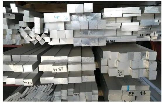 Various metal bars and sheets are stored in the warehouse.