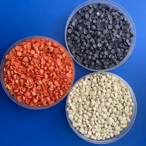 Three colors of plastic pellets used in the manufacture of injection molds.