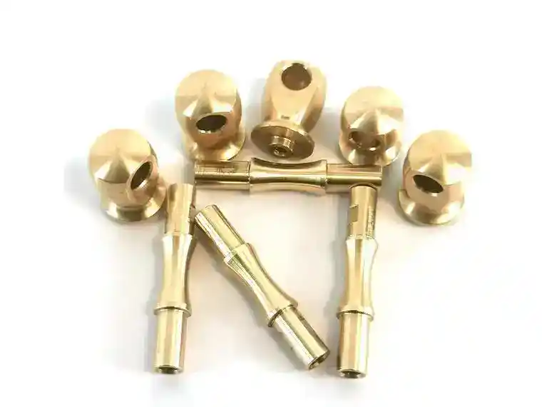 High-precision CNC machined brass components with threaded holes and smooth finish.