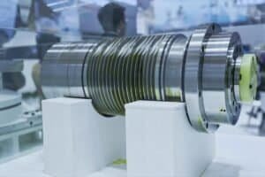 High-precision CNC machined metal component on display at a manufacturing exhibition.