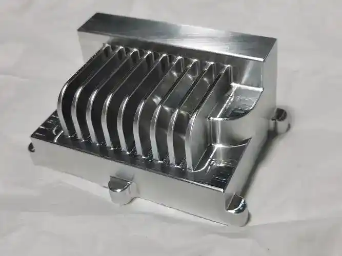 High-precision CNC machined metal part with multiple fins for industrial applications.