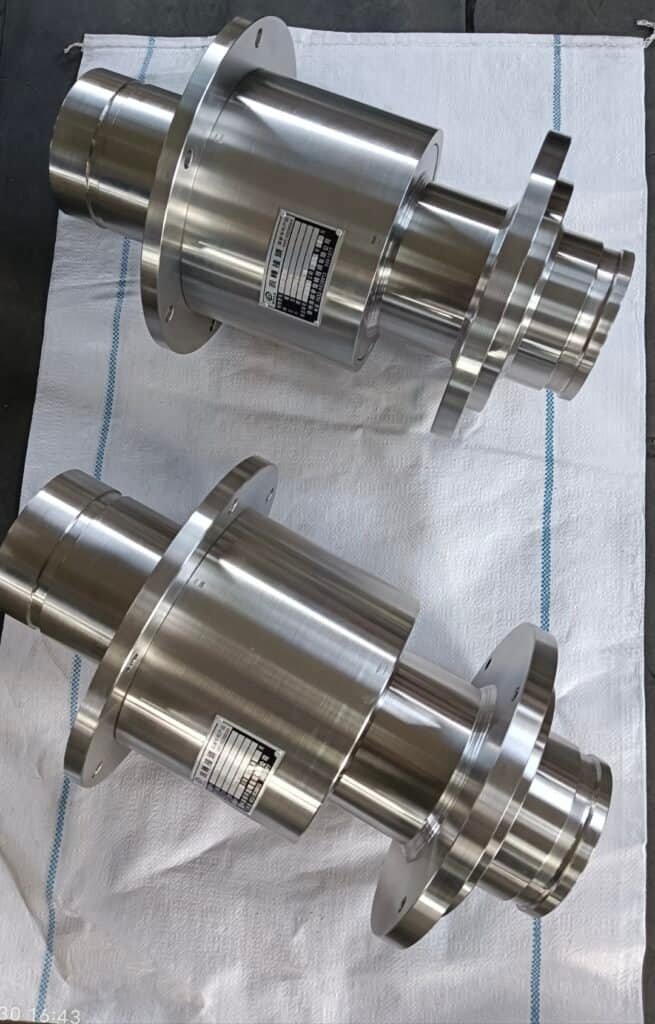 High-precision CNC machined metal components with flanges and labels.