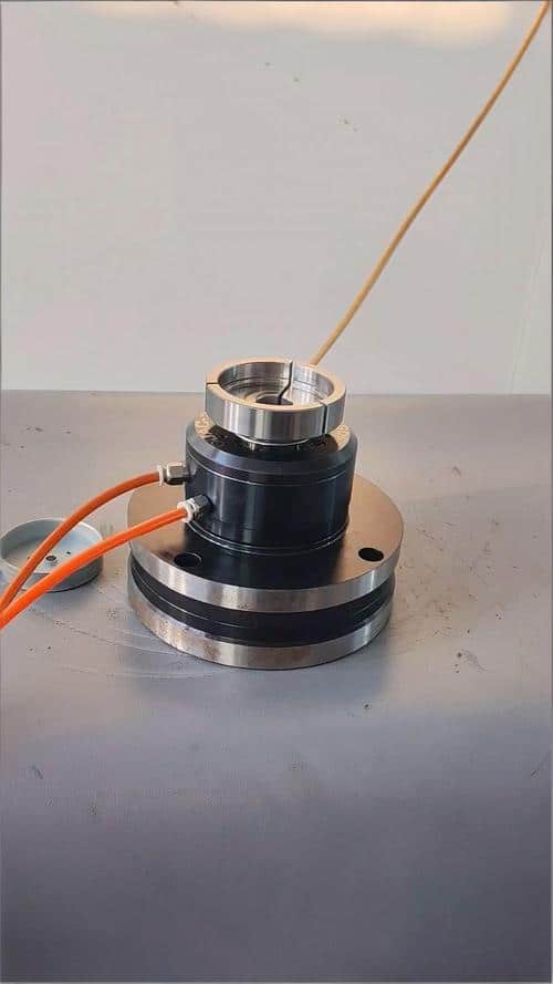 Precision CNC machined fitting with electrical wiring for industrial applications.
