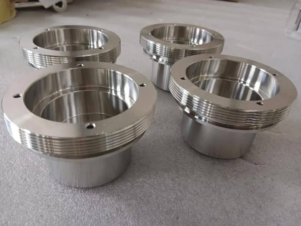 Precision-machined stainless steel CNC parts with threaded edges for industrial use.