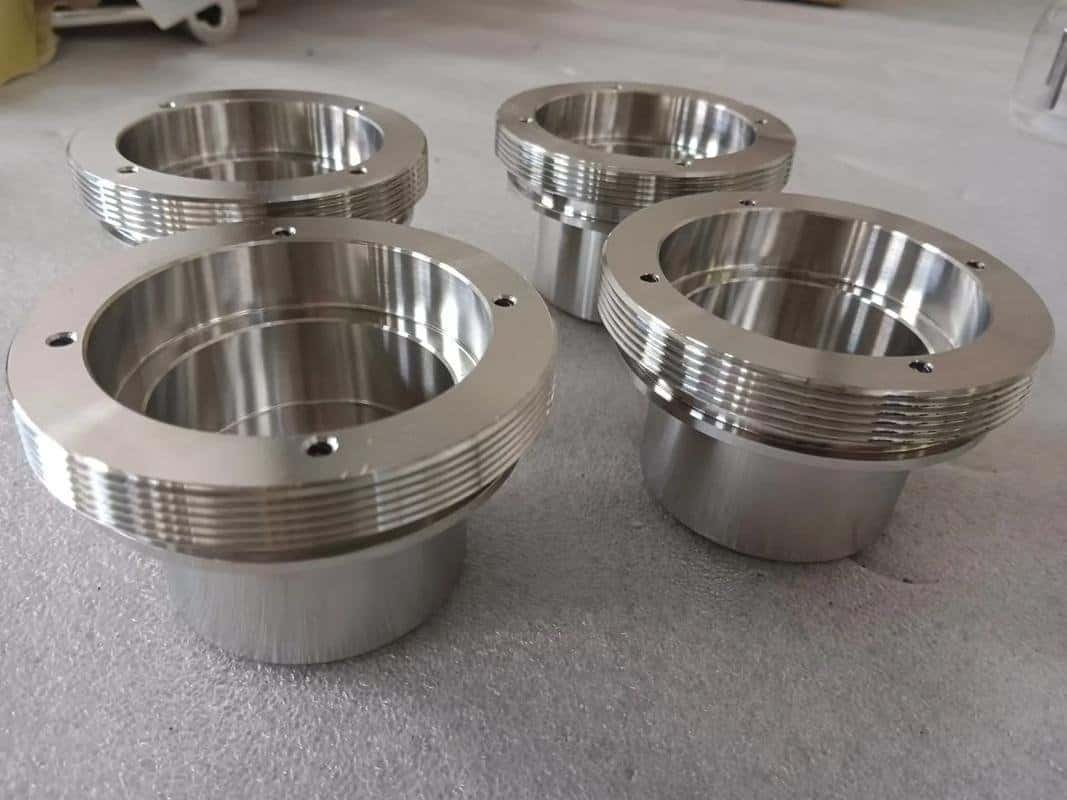 Precision machined metal components with threaded edges for industrial use.