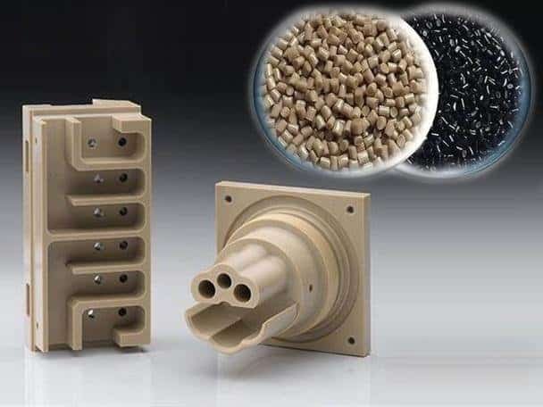 High-precision custom CNC machined plastic parts with black and beige pellets.
