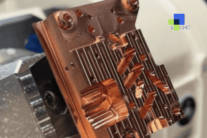Close-up of a copper alloy CNC machined part with intricate details and conductive features.