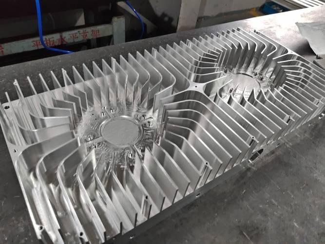 Aluminum CNC machined heat sink with fins for electronic cooling applications.