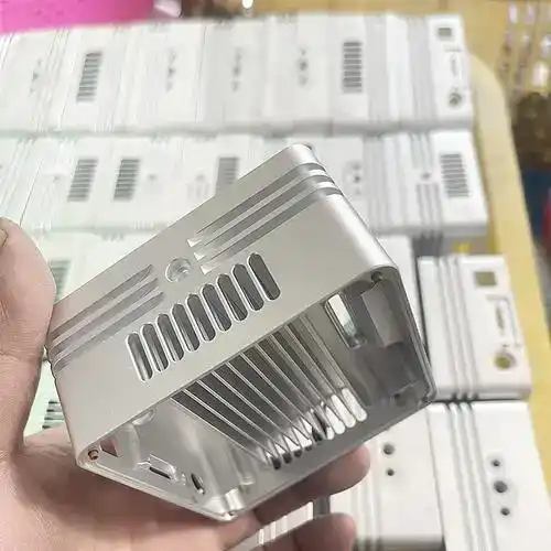 Custom machined aluminum enclosure with ventilation slots for electronics.