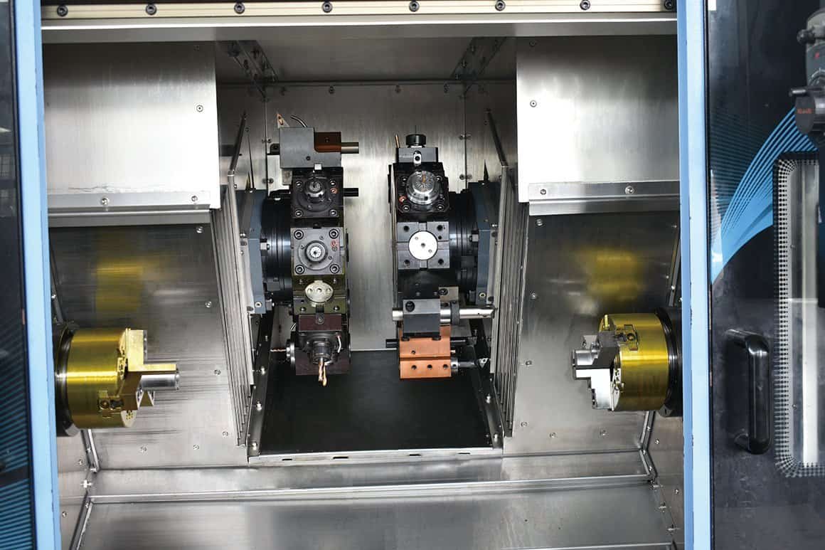 Multi-axis mill-turn center with dual spindles and a B-axis powered turret