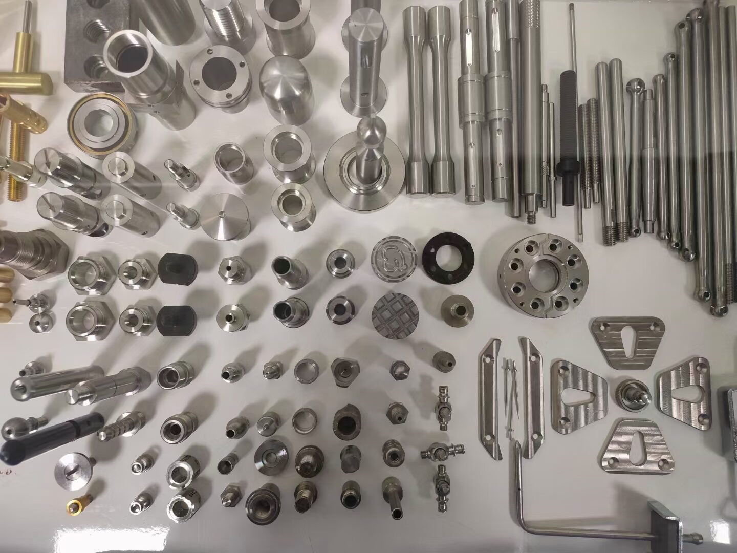 Display of custom Swiss machined shafts, sleeves, fittings, and small components