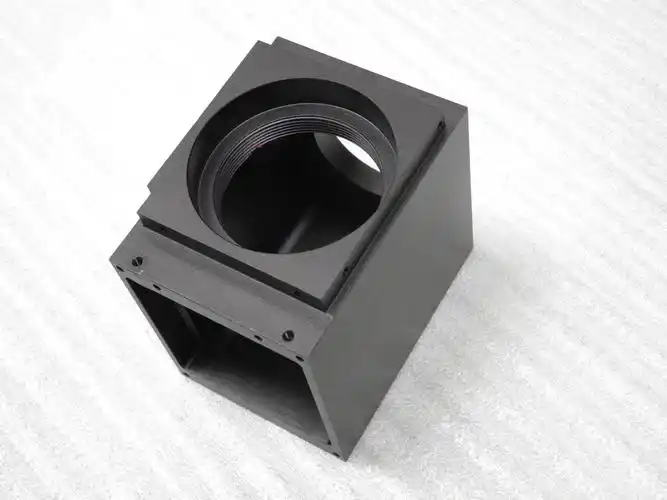 Black optical housing with threaded bore