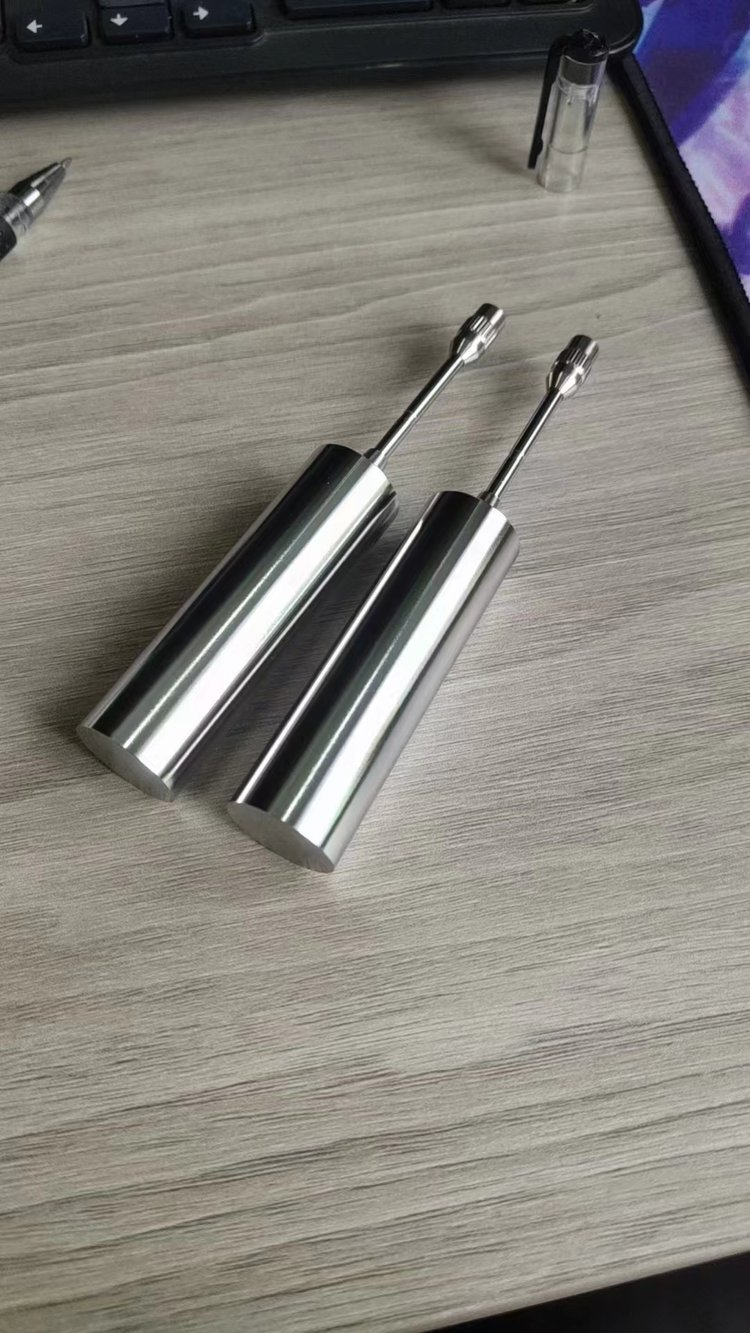 Two polished cylindrical metal components