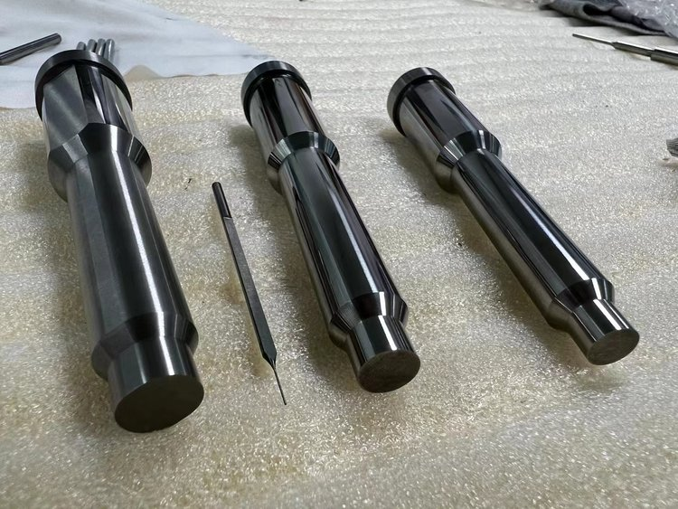 Three precision machined stepped shafts