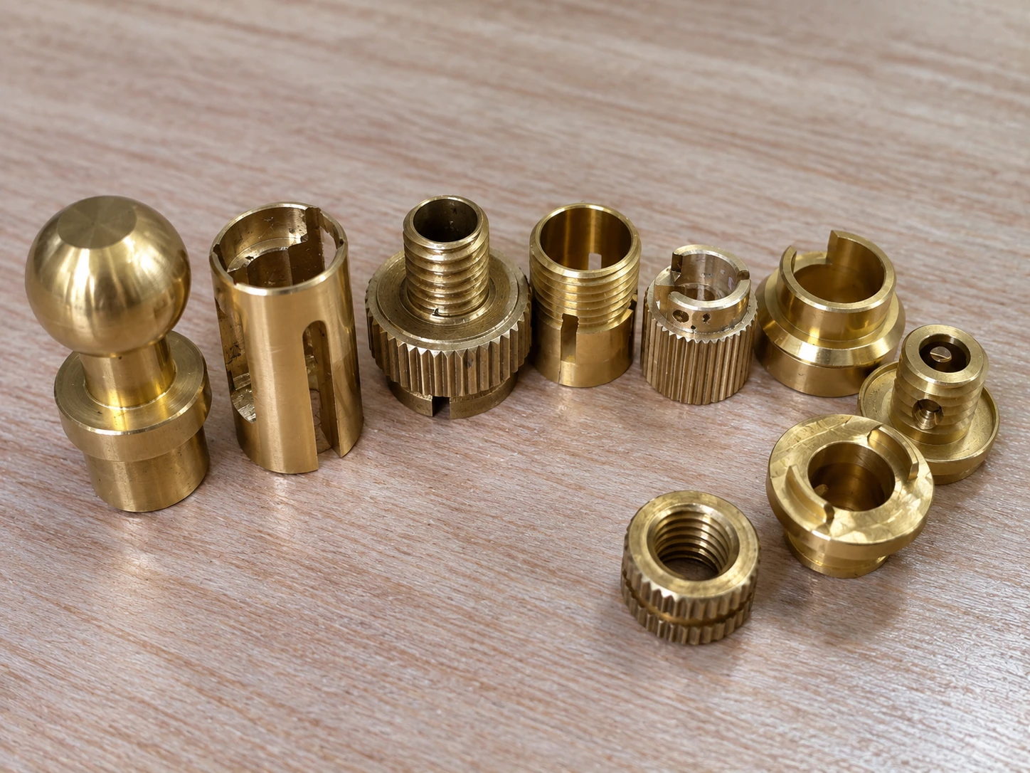 Assorted turned brass fittings and threaded inserts