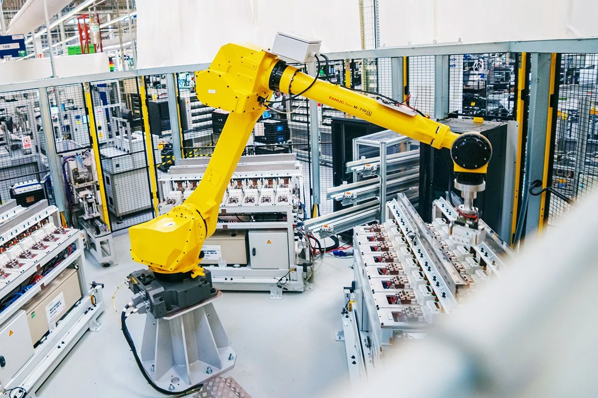 Industrial robot handling components in an automated production cell