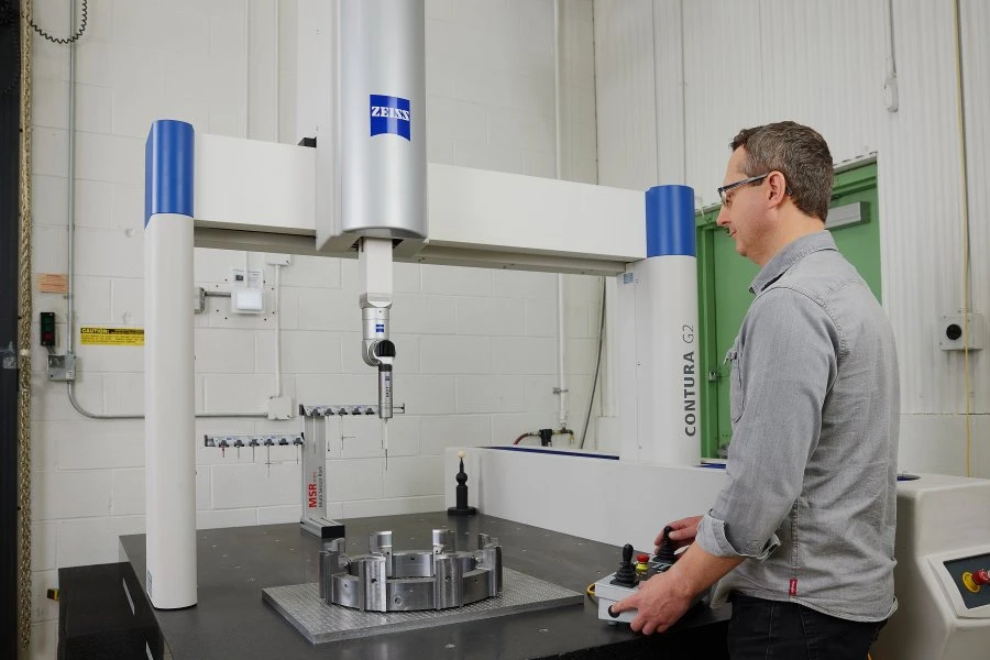 Operator using a coordinate measuring machine for quality inspection